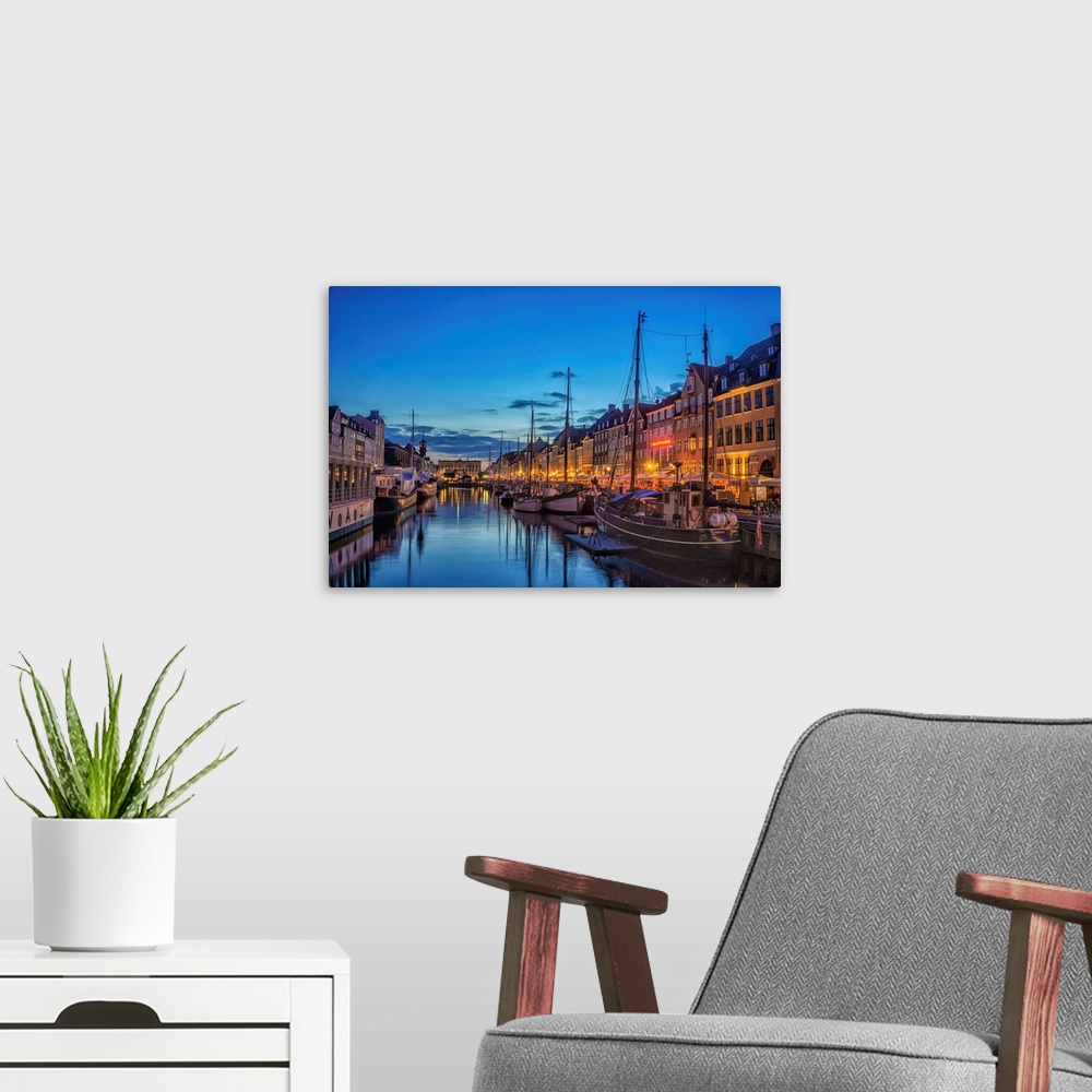 A modern room featuring Waterfront with boats in the evening, Copenhagen, Denmark.