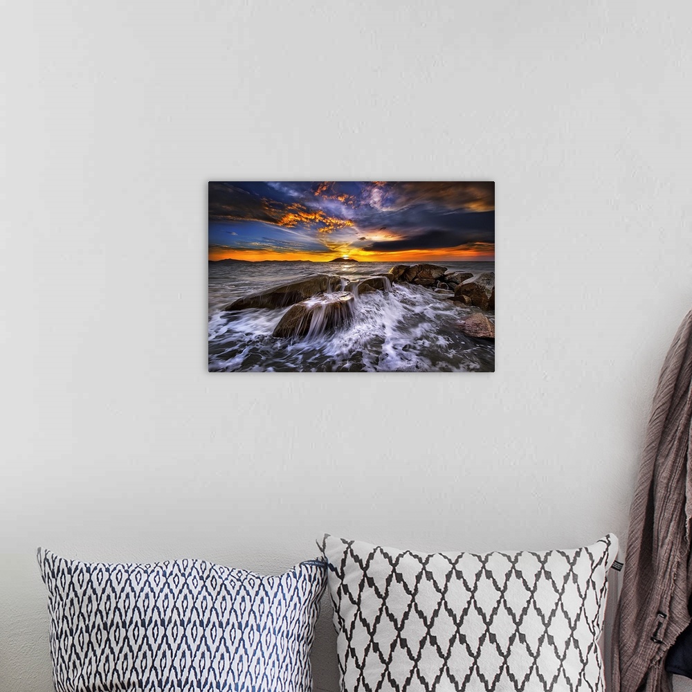 A bohemian room featuring Photograph of a seascape at sunset with intense warm and cold clouds in the sky.