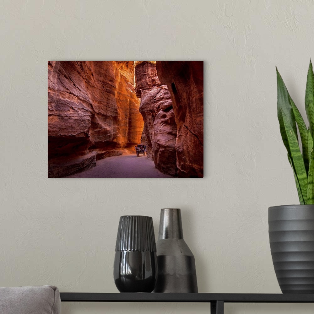 A modern room featuring Red rock canyon walls in Petra, Jordan.