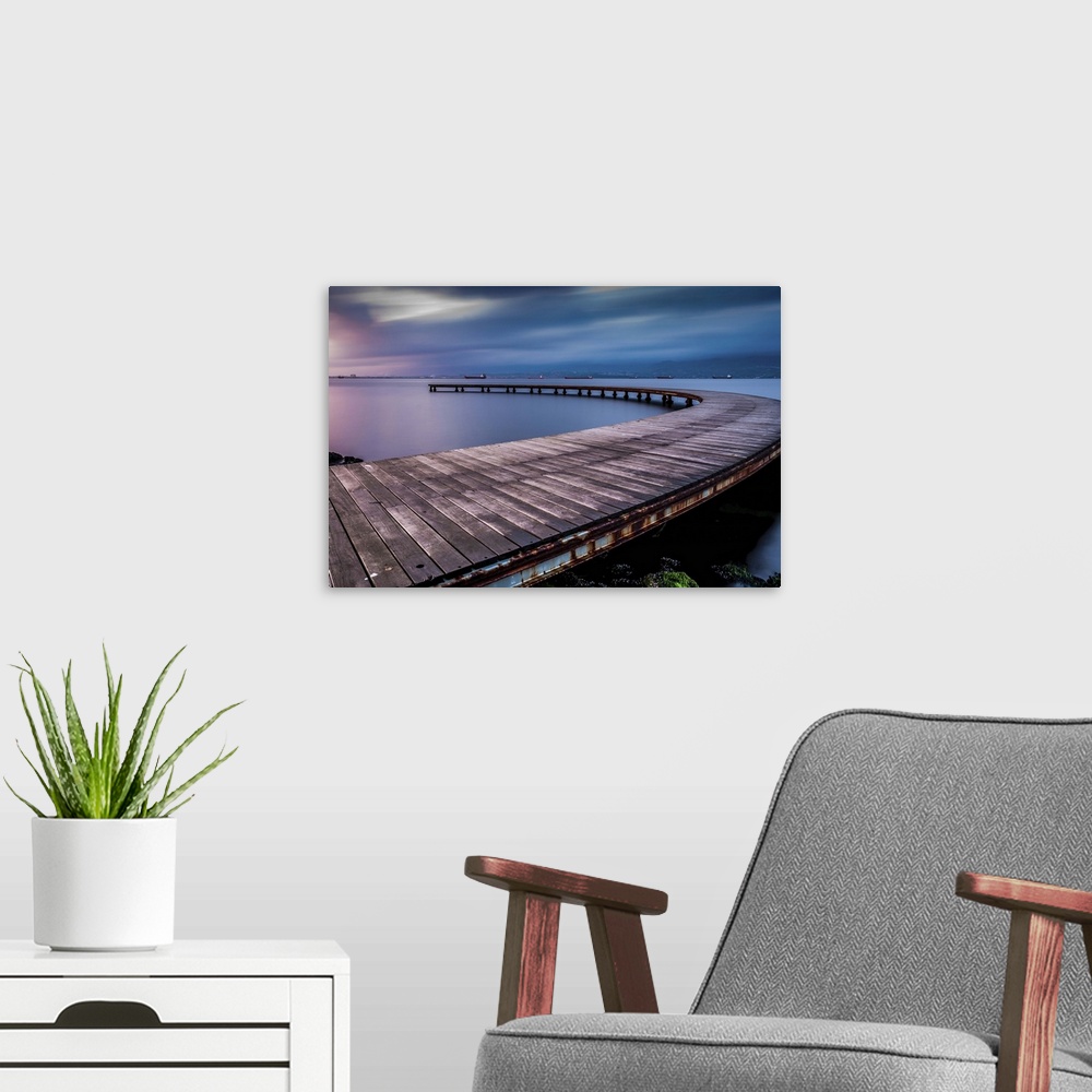 A modern room featuring Dynamic photograph of a curved pier jetting out over the water.