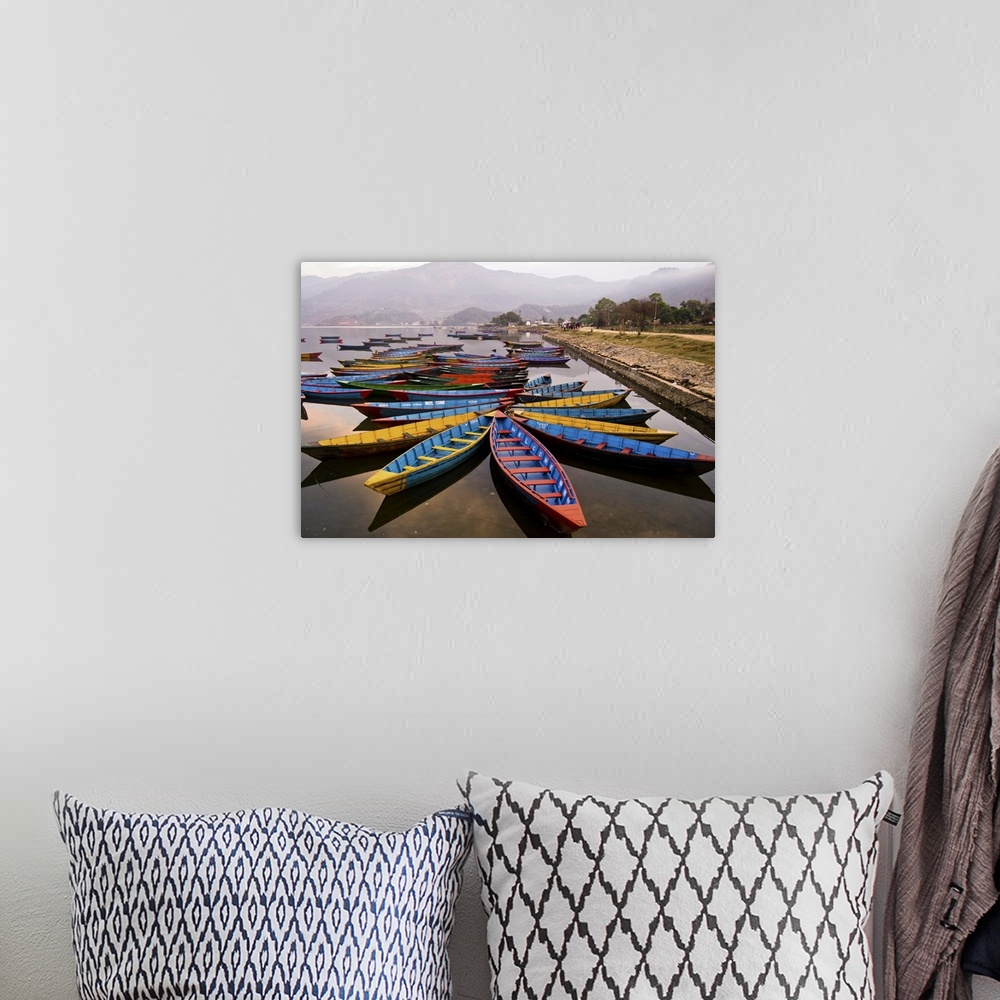 A bohemian room featuring Long tail boats in star formations in a misty harbor in Nepal.