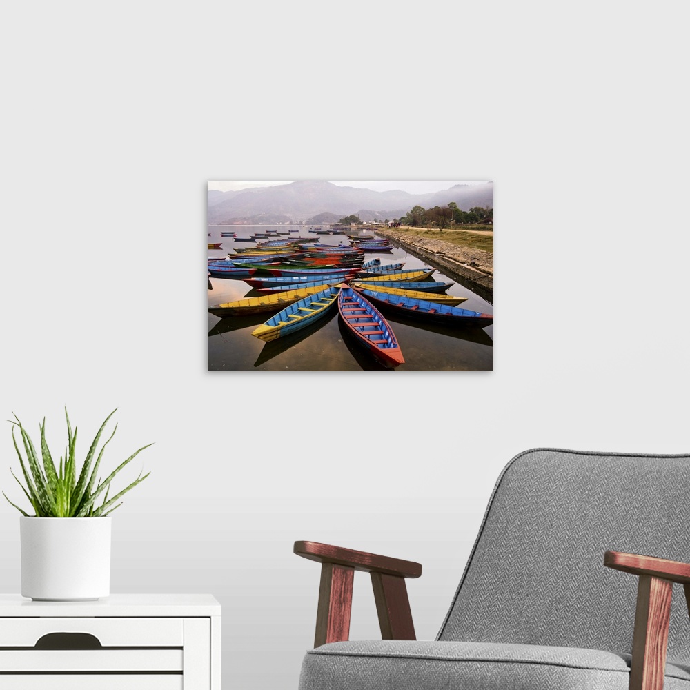 A modern room featuring Long tail boats in star formations in a misty harbor in Nepal.