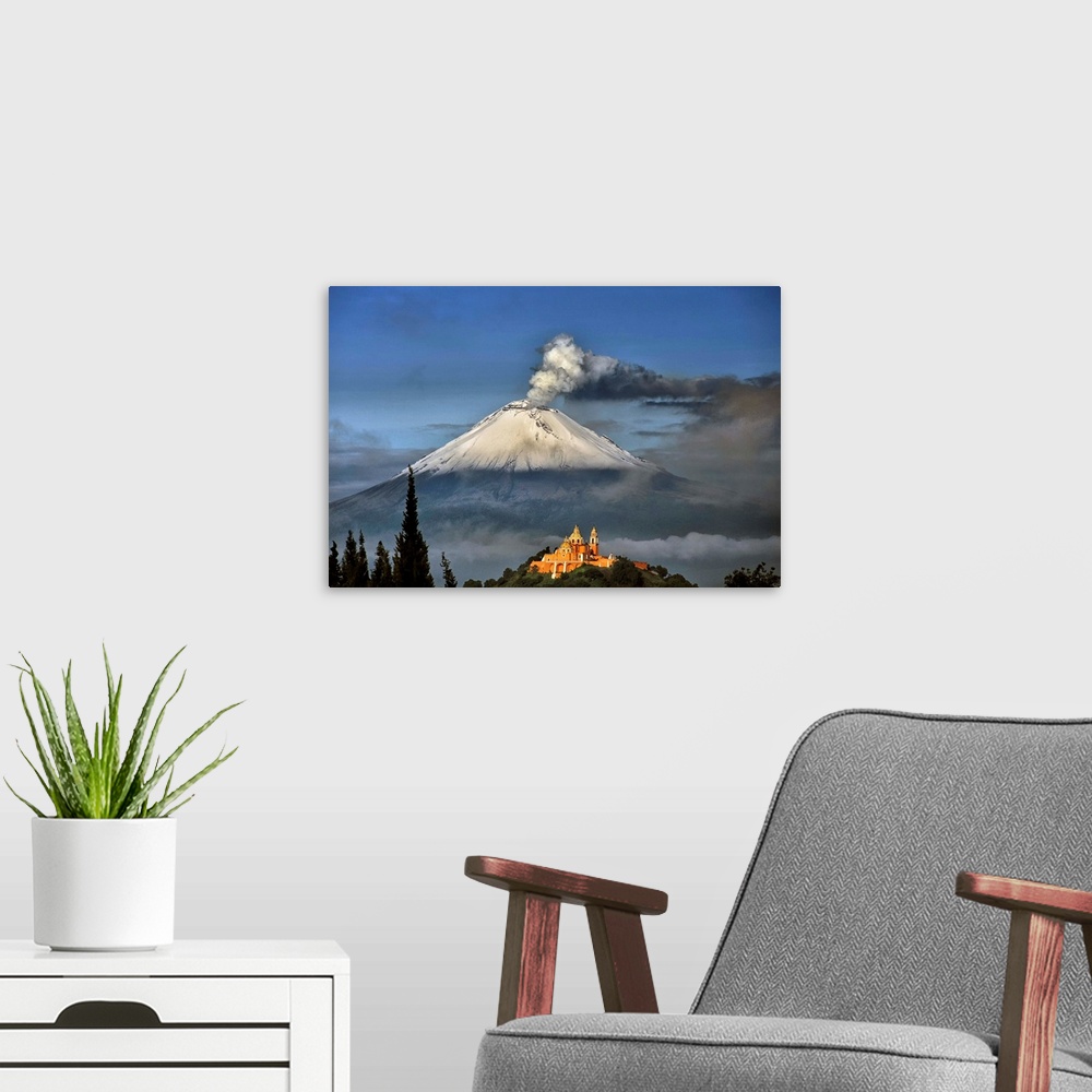 A modern room featuring Popocatepetl, snowy and smoking with Choluula church in the foreground.