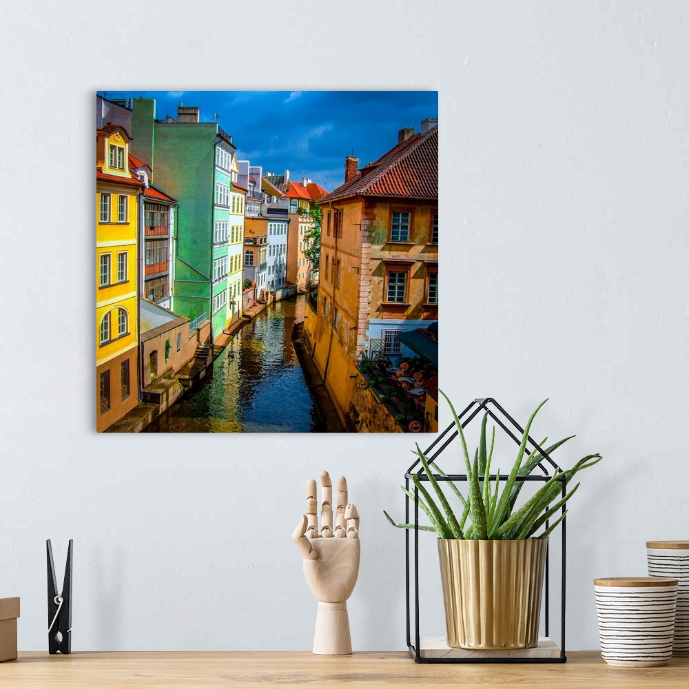 A bohemian room featuring Colorful buildings along the canal in Prague.