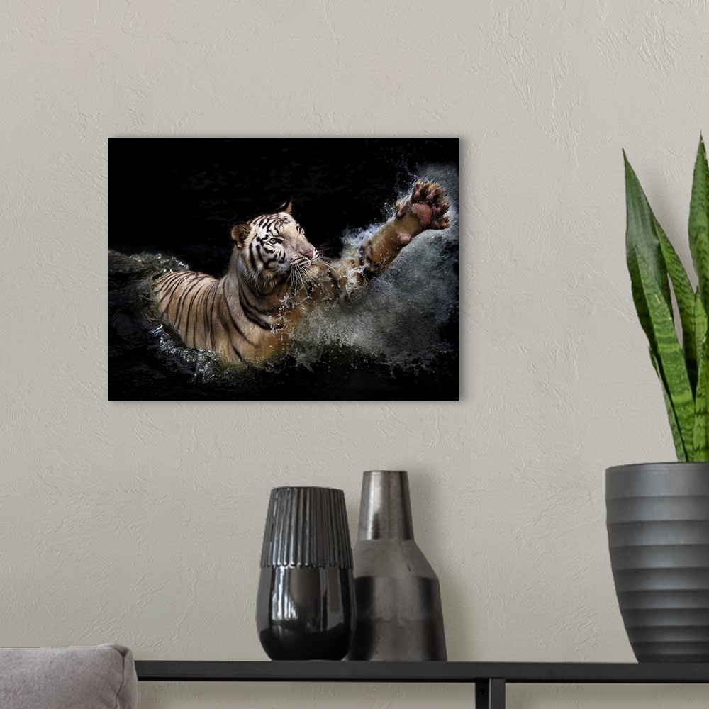 A modern room featuring A photograph of a tiger leaping up into the air from shallow water.
