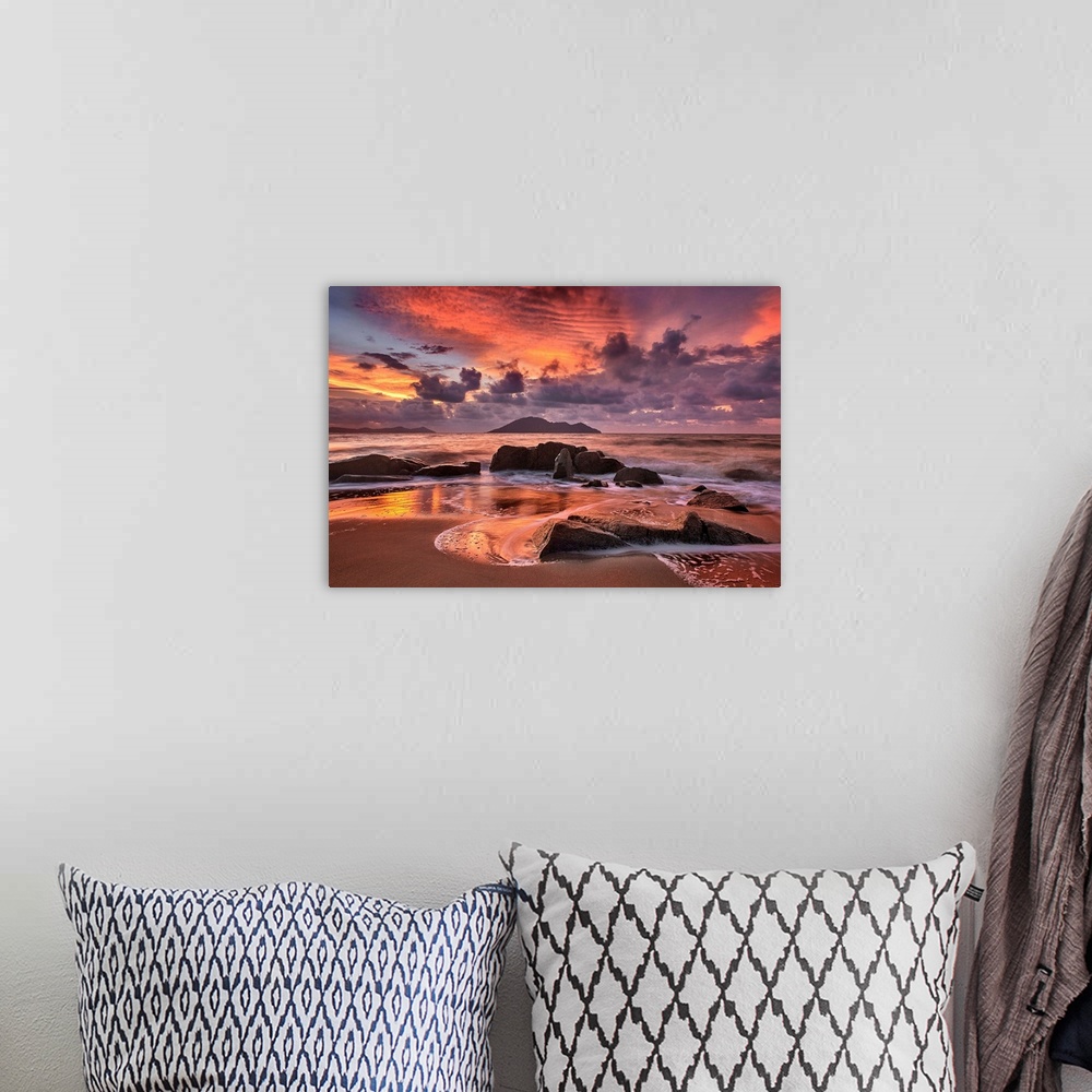A bohemian room featuring Rocky beach at sunset, with dramatic clouds looming in the distance.