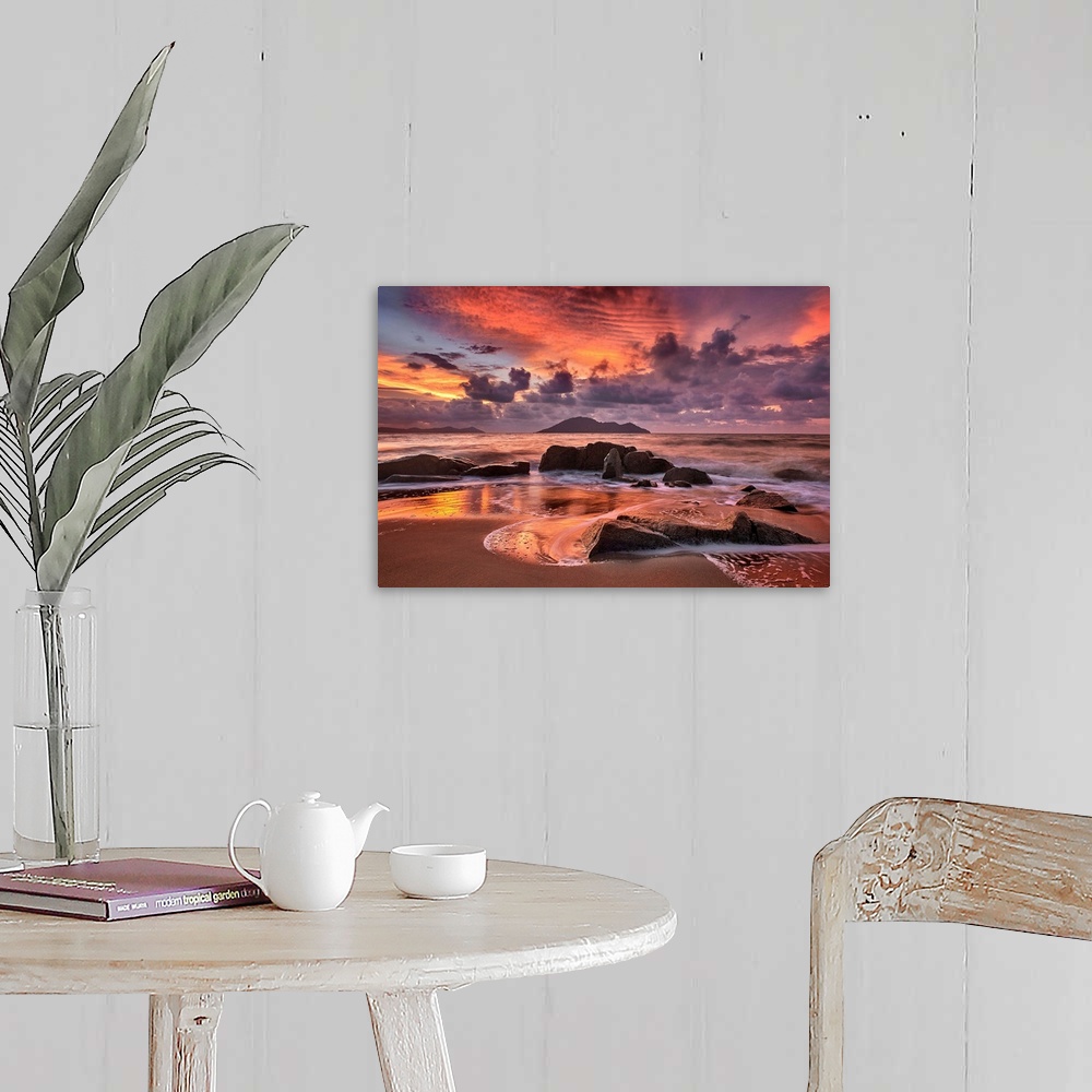 A farmhouse room featuring Rocky beach at sunset, with dramatic clouds looming in the distance.