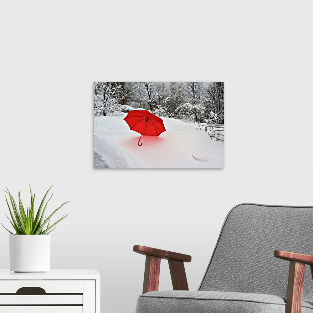 A modern room featuring A bright red umbrella stands out against the white snowscape.