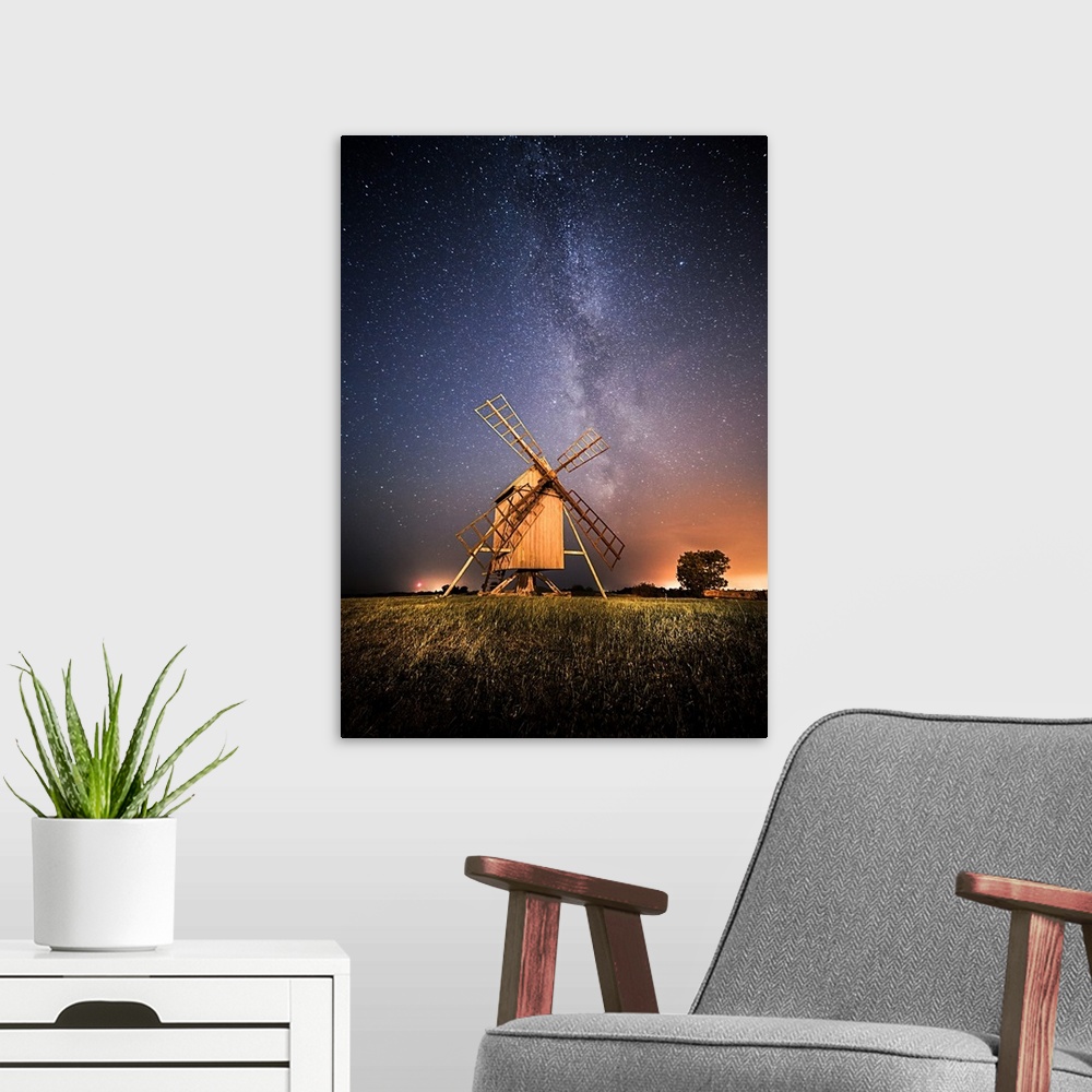 A modern room featuring Windmills at night under a starry sky, Resmo, Oland, Sweden.
