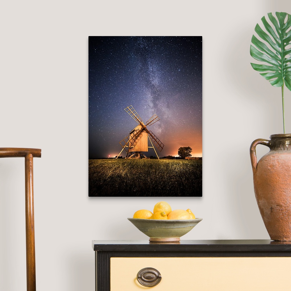 A traditional room featuring Windmills at night under a starry sky, Resmo, Oland, Sweden.