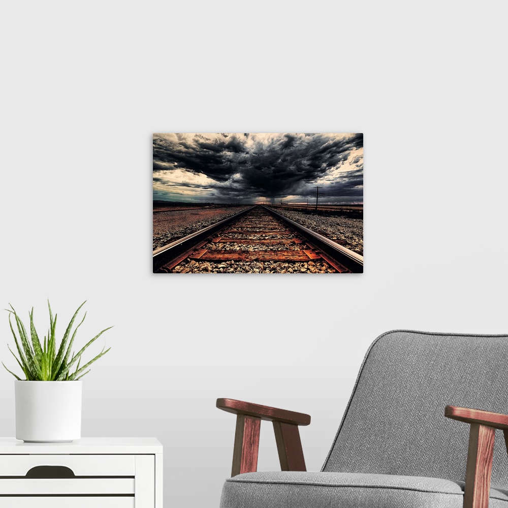 A modern room featuring Dark storm clouds over iron railroad tracks.