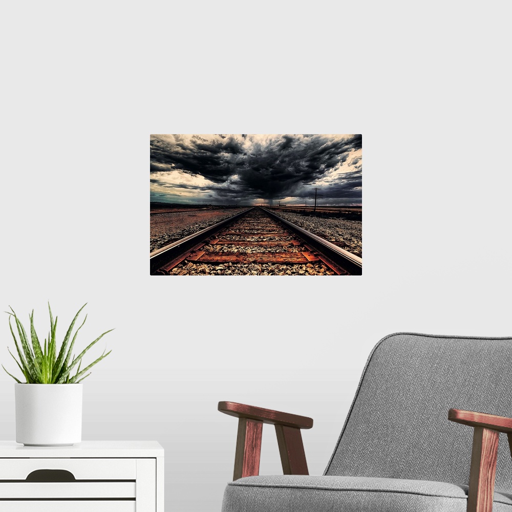 A modern room featuring Dark storm clouds over iron railroad tracks.