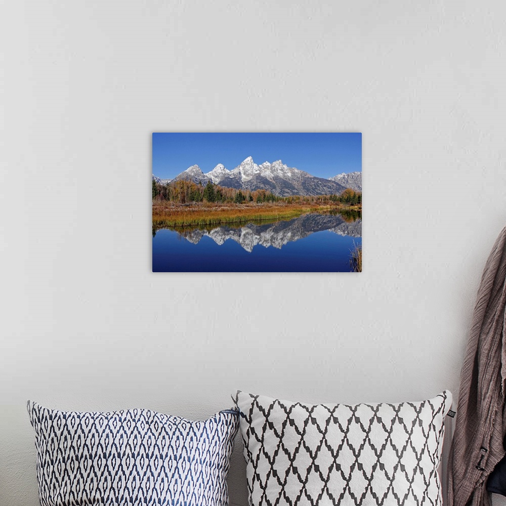 A bohemian room featuring The Grand Tetons reflected on the Snake river near Jackson, Wyoming.