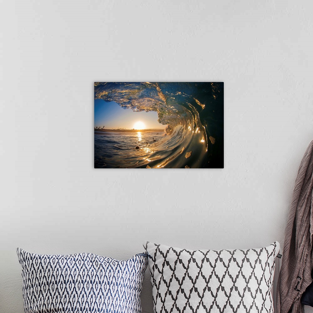 A bohemian room featuring Large ocean wave arcing over the setting sun on the horizon.