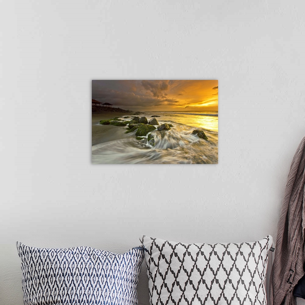 A bohemian room featuring Beautiful sunset over low tidewater rushing over rocks on the beach.