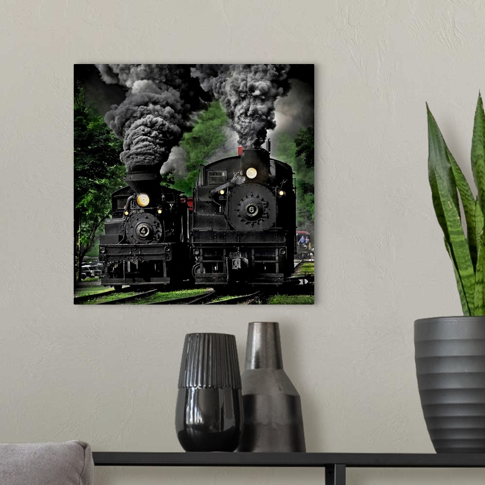A modern room featuring Two black locomotives approaching on the railroad tracks.