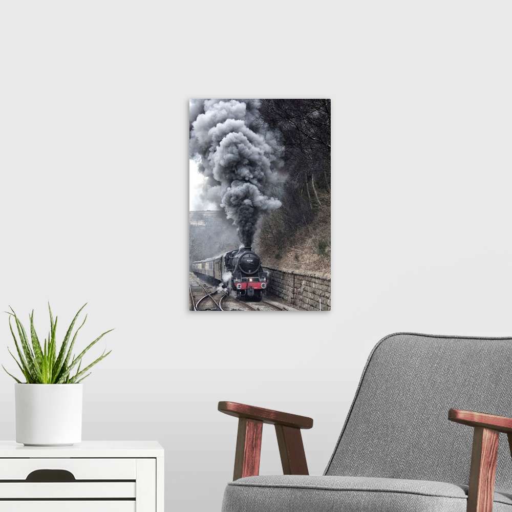 A modern room featuring Lots of steam from a locomotive's smokestack.