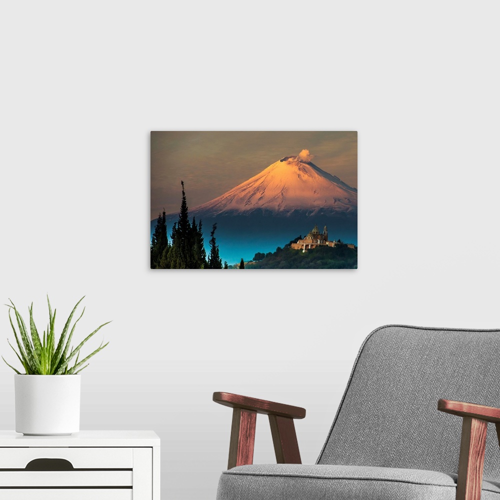A modern room featuring Clouds of ash rising from snowy  Popocatepetl volcano, Mexico.