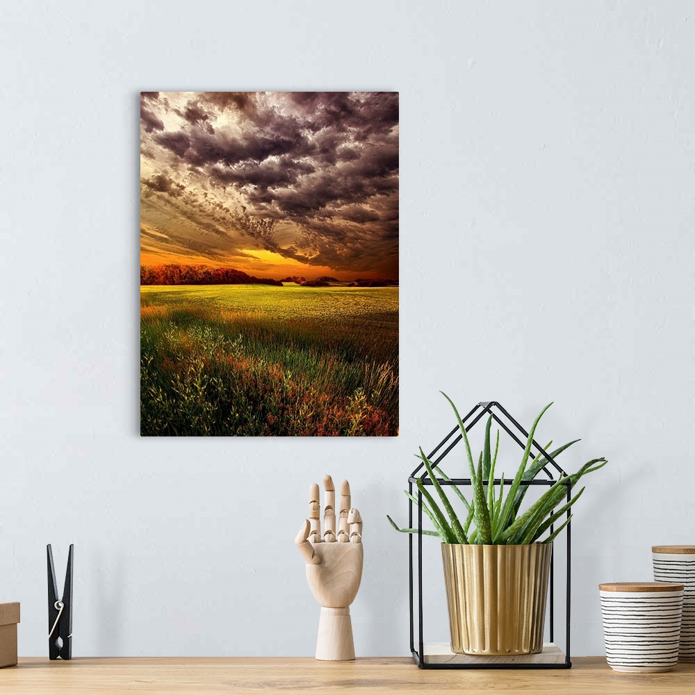 A bohemian room featuring Dramatic cloudscape at sunset over a field of farmland.