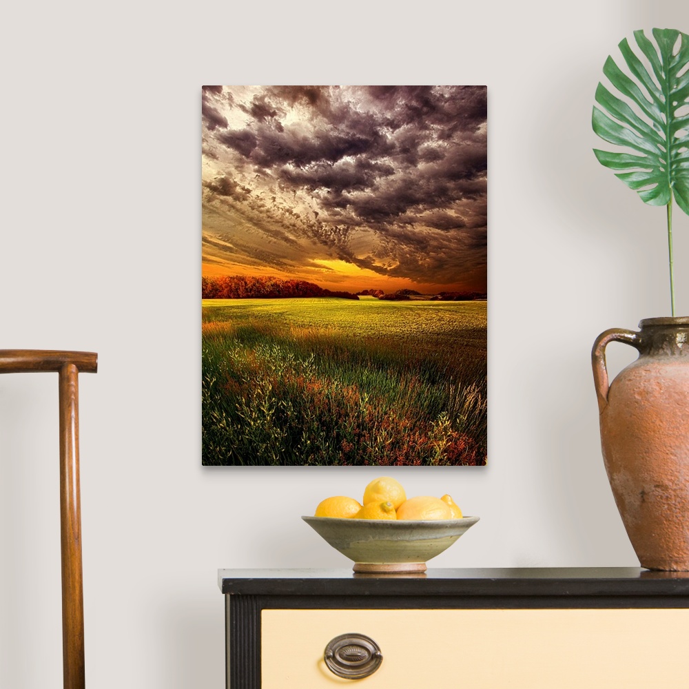 A traditional room featuring Dramatic cloudscape at sunset over a field of farmland.