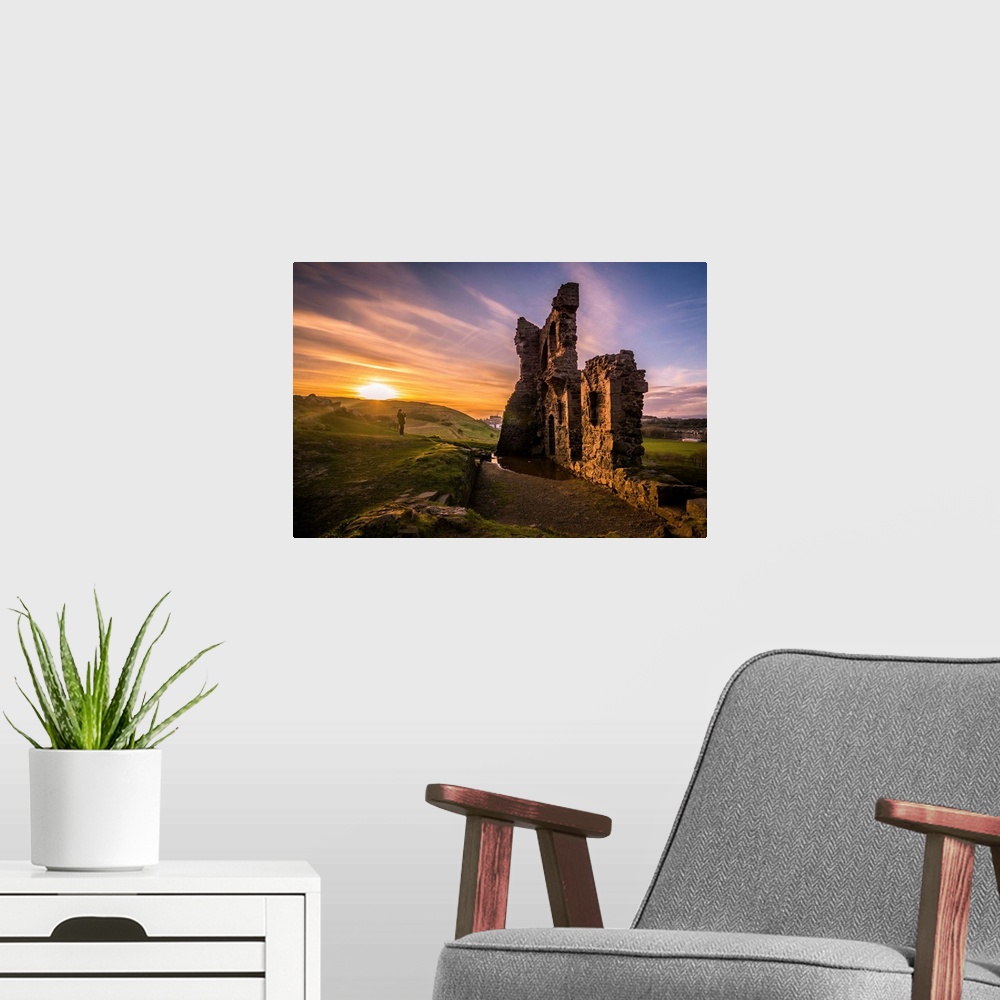 A modern room featuring Sun setting on the horizon near the ruins of St. Anthony's Chapel in Edinburgh, Scotland.