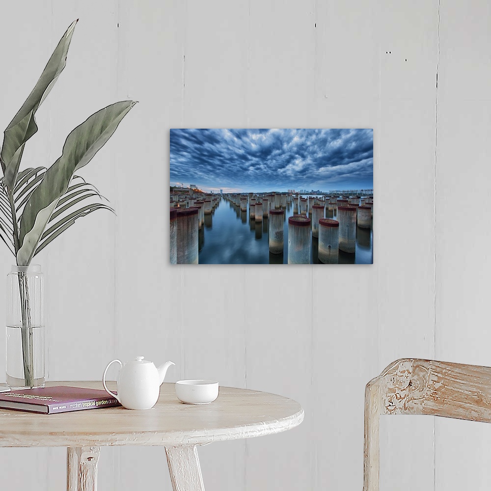 A farmhouse room featuring Dynamic photograph of pier posts in formation in a flat reflective watery surface.