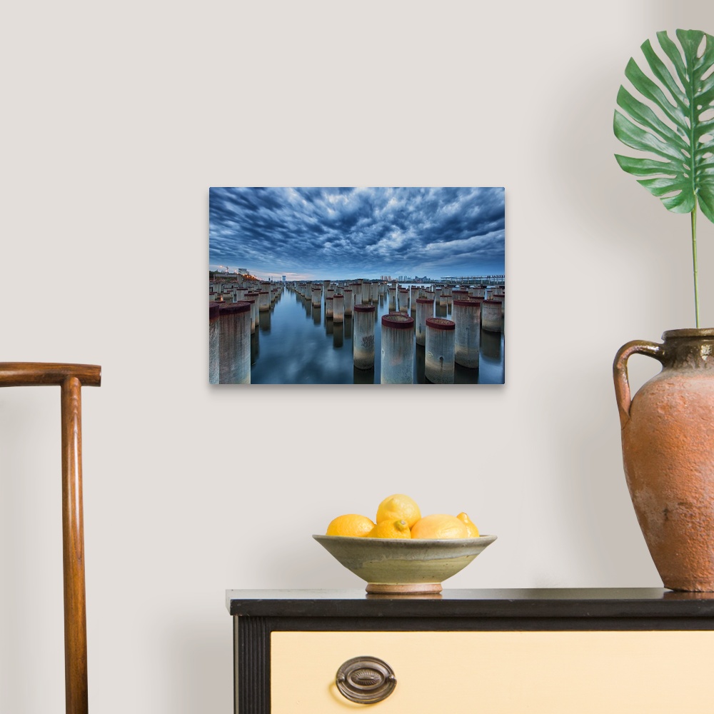 A traditional room featuring Dynamic photograph of pier posts in formation in a flat reflective watery surface.