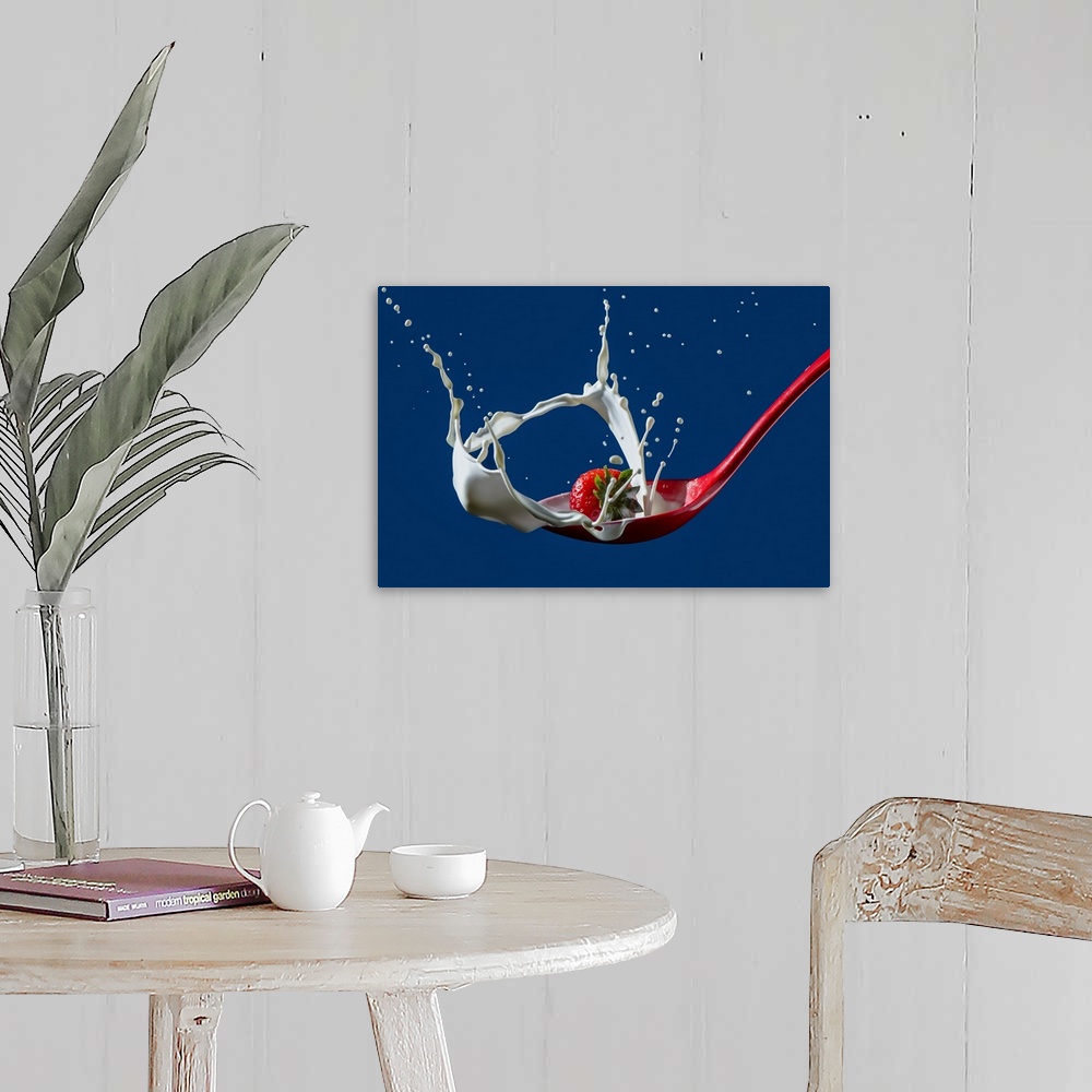 A farmhouse room featuring High-speed shot of a strawberry splashing into a ladle of cream.