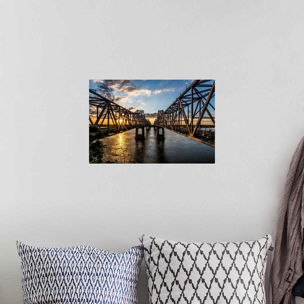A bohemian room featuring Light from the setting sun on the Natchez Bridges over the Mississippi River.