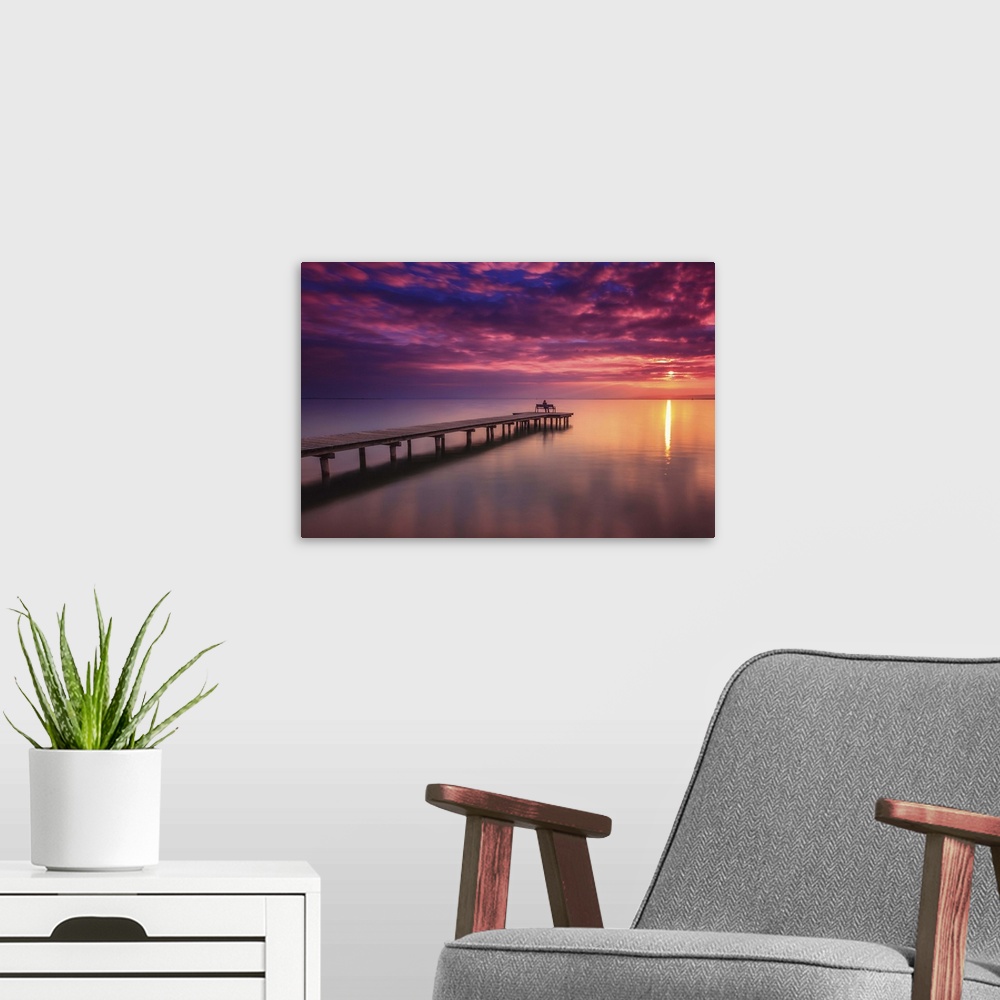 A modern room featuring A pier in Lake Neusiedl at sunset, Austria.