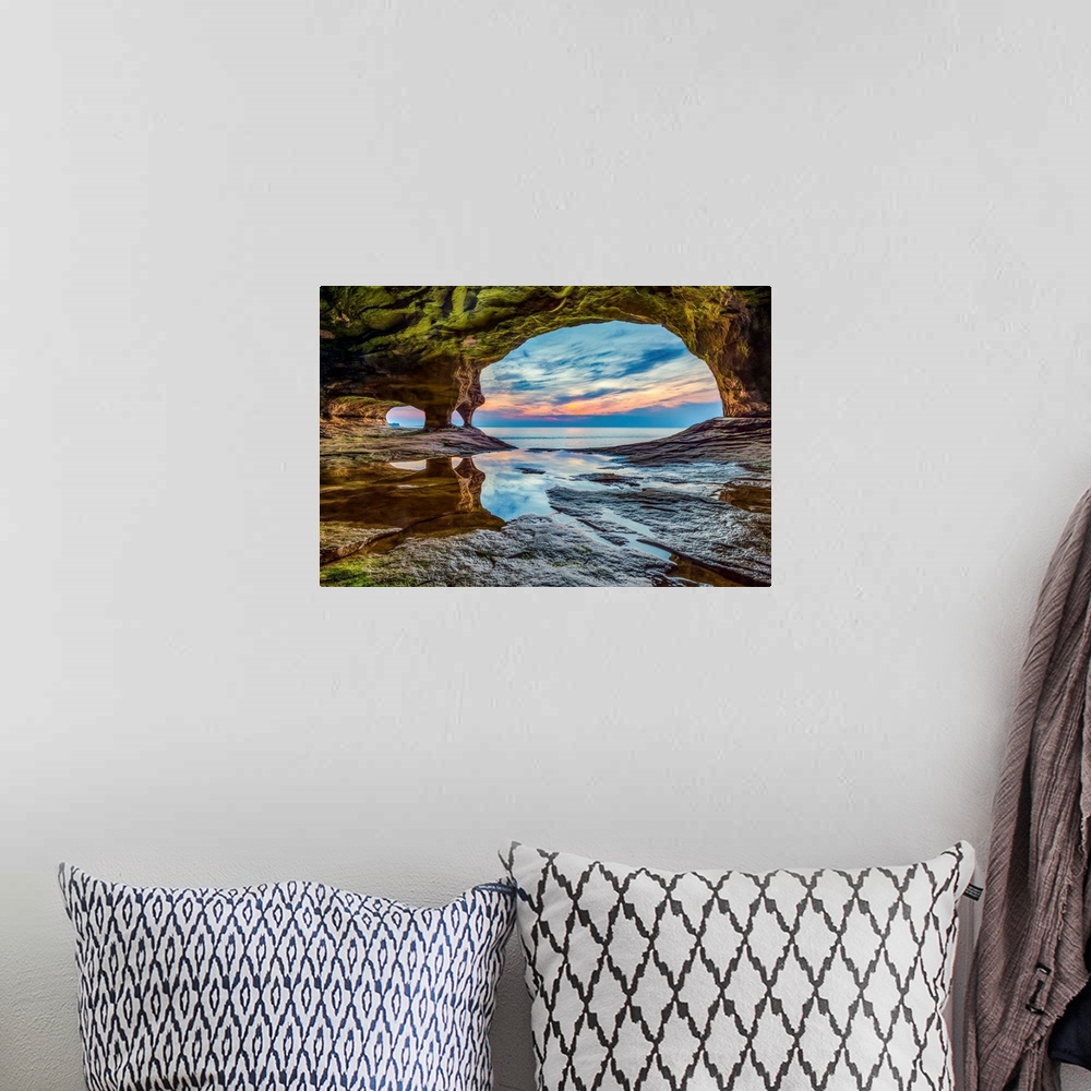 A bohemian room featuring The sun sets on Lake Superior as photographed from a sea cave on a stretch of rocky coast in Mich...