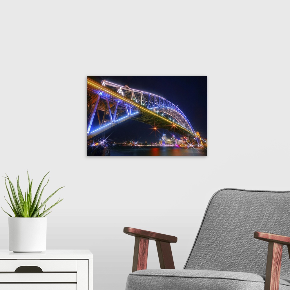 A modern room featuring Photograph of the Sydney Harbor skyline from under the massive neon lit bridge.