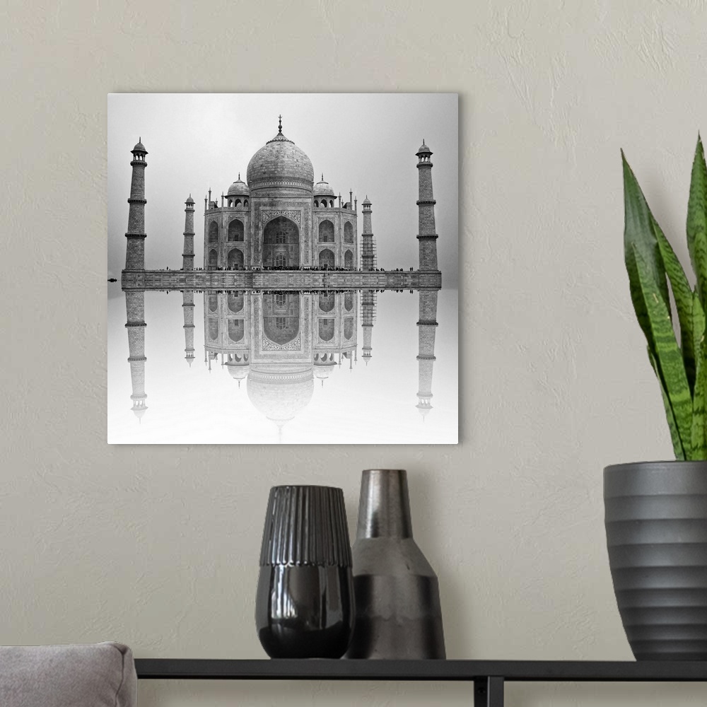 A modern room featuring Black and white photo of the Taj Mahal reflected in the water below.