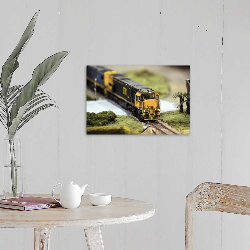 A farmhouse room featuring A realistic model train, 1:64 scale.