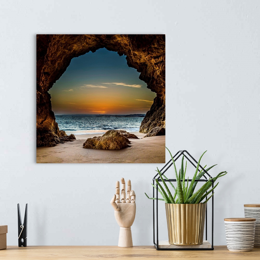 A bohemian room featuring View from inside a cave on the beach, looking out at the sunset, Ferragudo, Portugal.