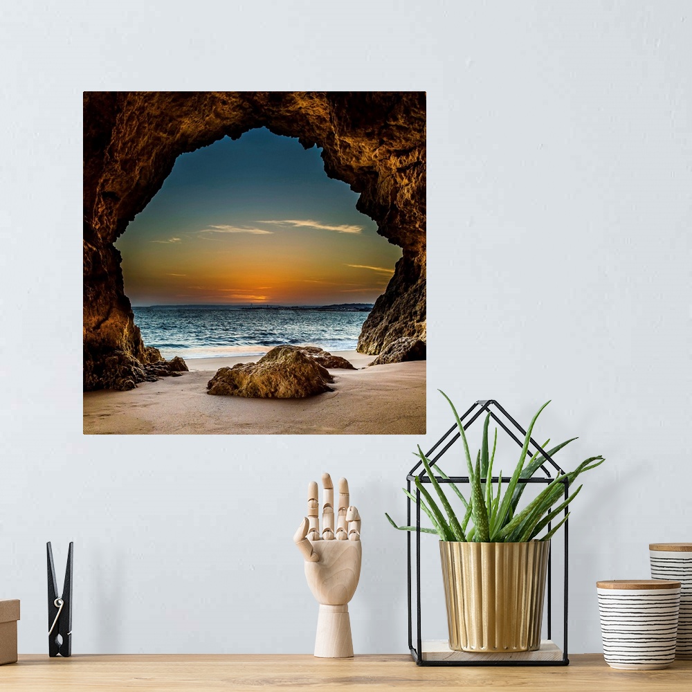A bohemian room featuring View from inside a cave on the beach, looking out at the sunset, Ferragudo, Portugal.