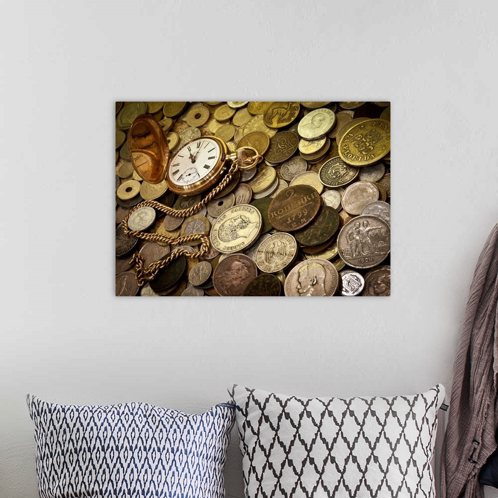 A bohemian room featuring A collection of coins with a gold pocketwatch.