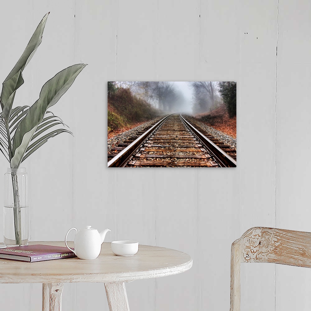 A farmhouse room featuring Railroad tracks leading into the fog in the morning.