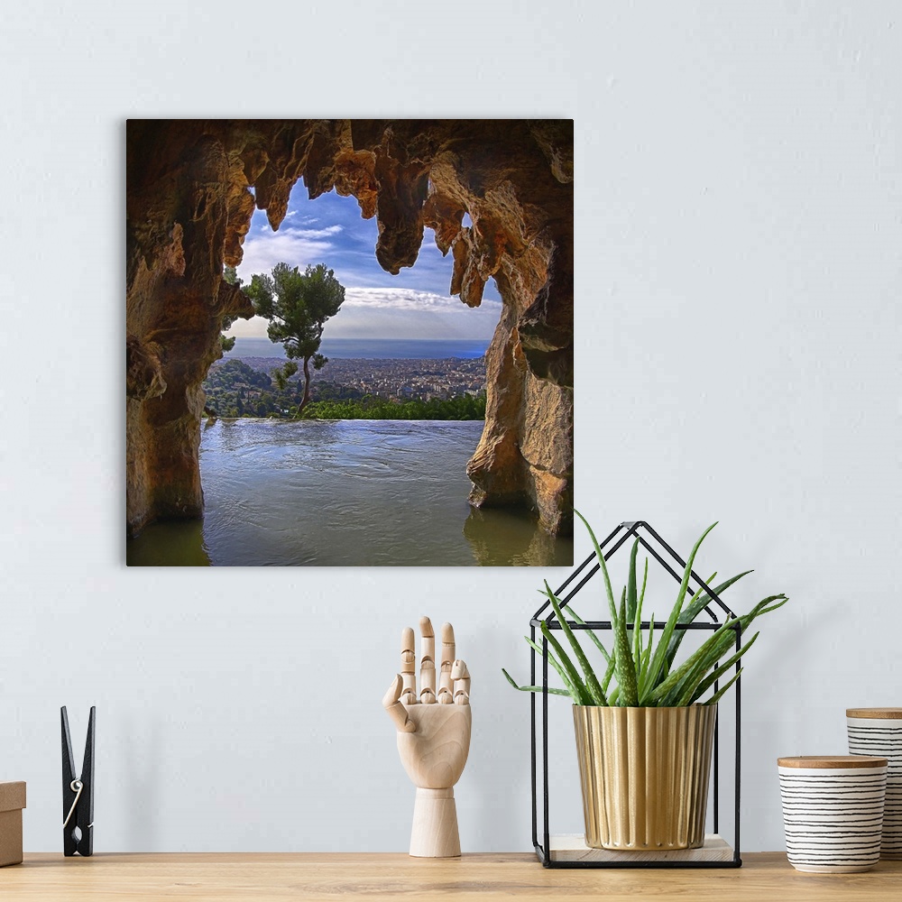 A bohemian room featuring Nice, France, as seen from inside a cave.