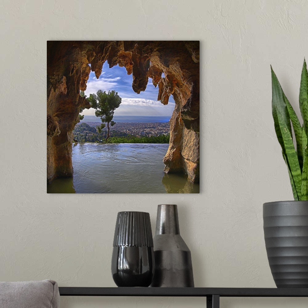A modern room featuring Nice, France, as seen from inside a cave.