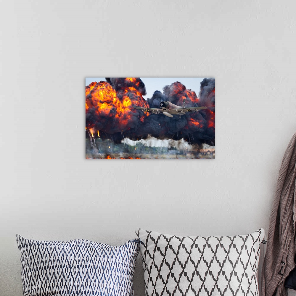 A bohemian room featuring A military plane flies away from large fiery smoke clouds created by explosions.