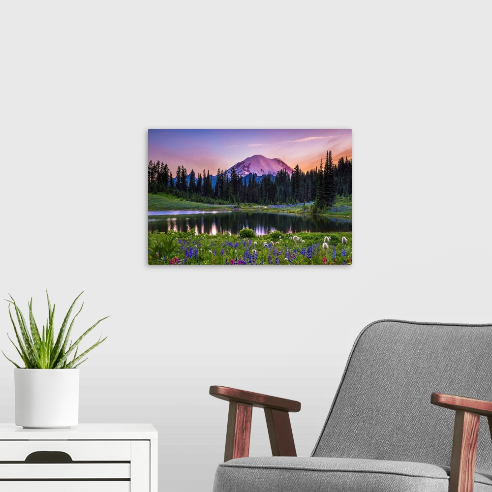 A modern room featuring Flowers along the edge of a lake with Mount Rainier in the distance, at sunset.
