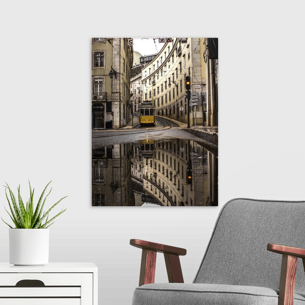 A modern room featuring An old street of Lisbon with a yellow train coming. Yellow traffic light. The street view reflect...