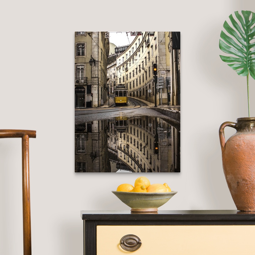 A traditional room featuring An old street of Lisbon with a yellow train coming. Yellow traffic light. The street view reflect...