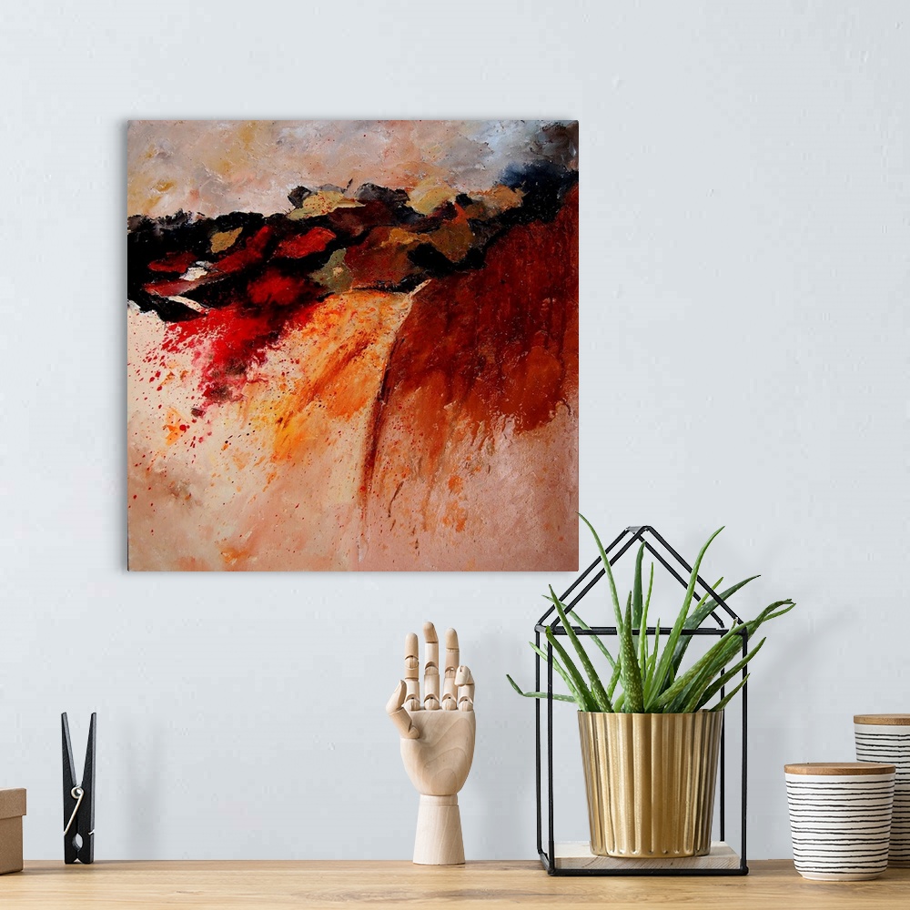 A bohemian room featuring Abstract painting of colors of orange, red and black in textured brush strokes and splattered paint.