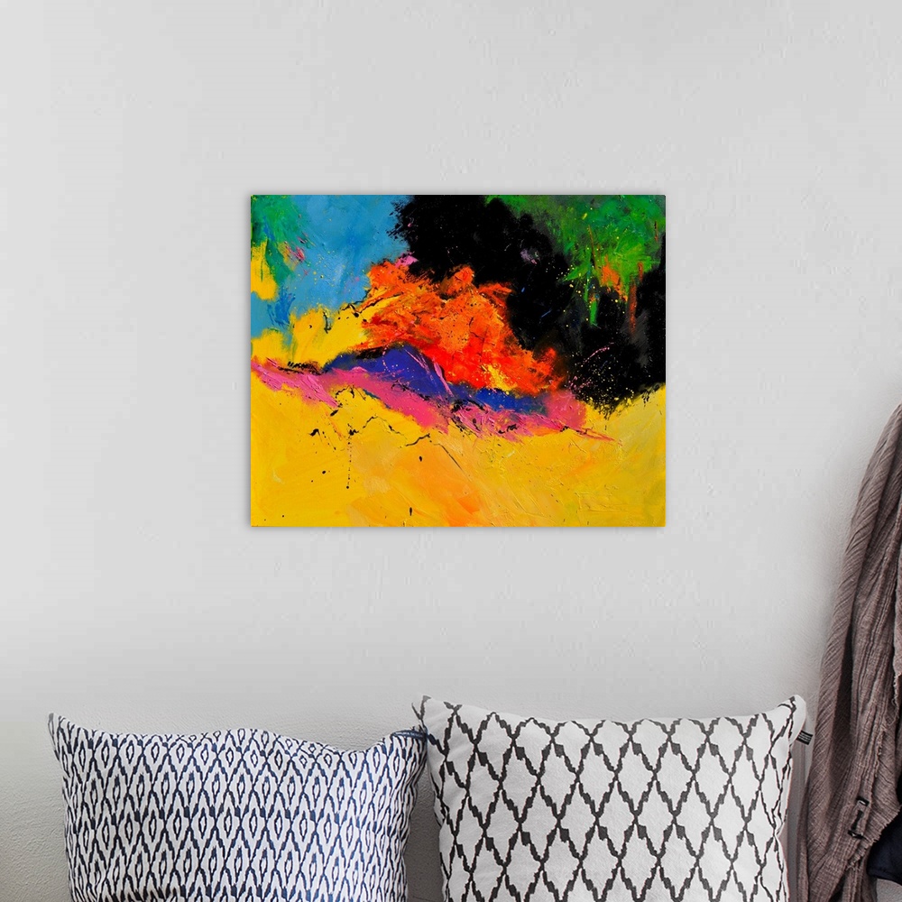 A bohemian room featuring A horizontal abstract painting in vibrant colors of yellow, orange, pink and green with splatters...