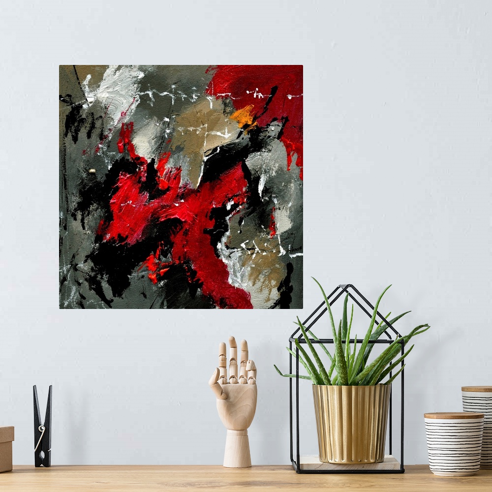 A bohemian room featuring A square abstract painting with deep textured colors of red and gray.