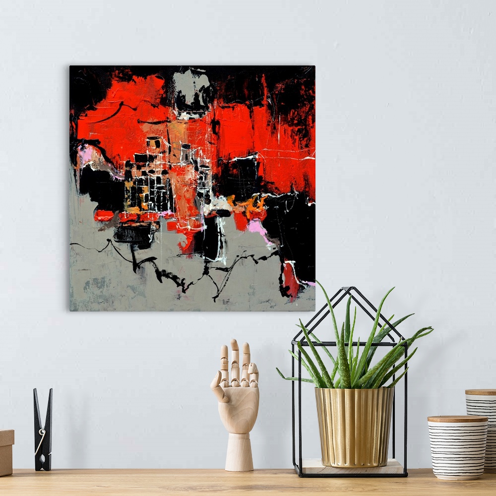 A bohemian room featuring A square abstract painting in shades of black, red, pink and orange with splatters of paint overl...