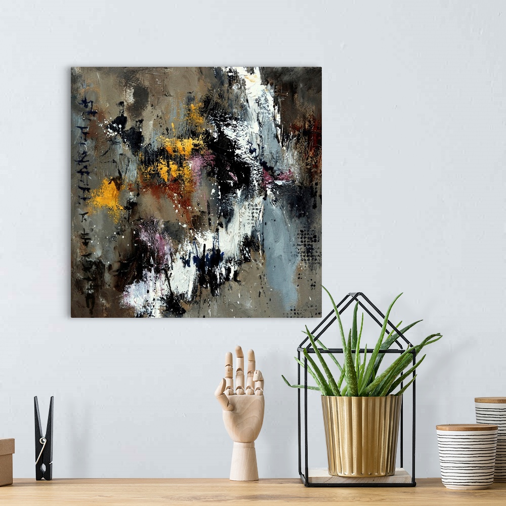 A bohemian room featuring A square abstract painting with shades of gray and brown with yellow accents.