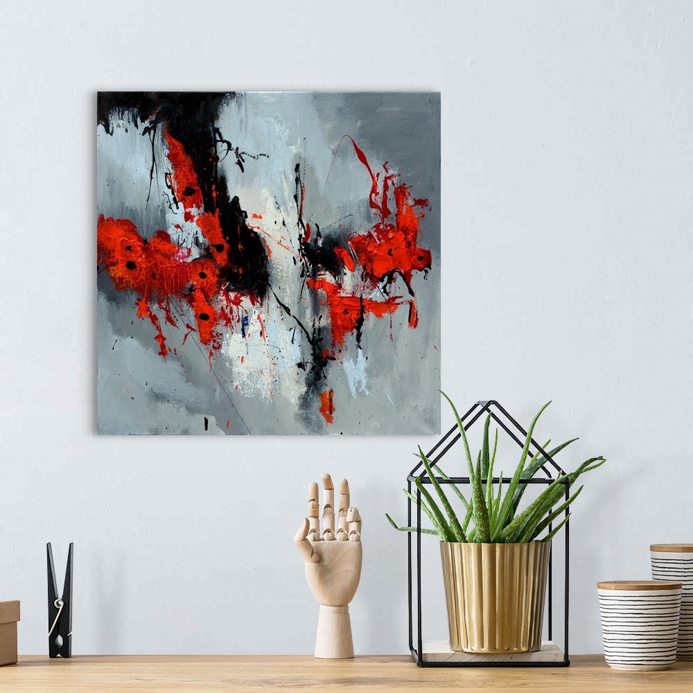 A bohemian room featuring A square abstract painting in textured shades of black, red, white and gray with splatters of pai...